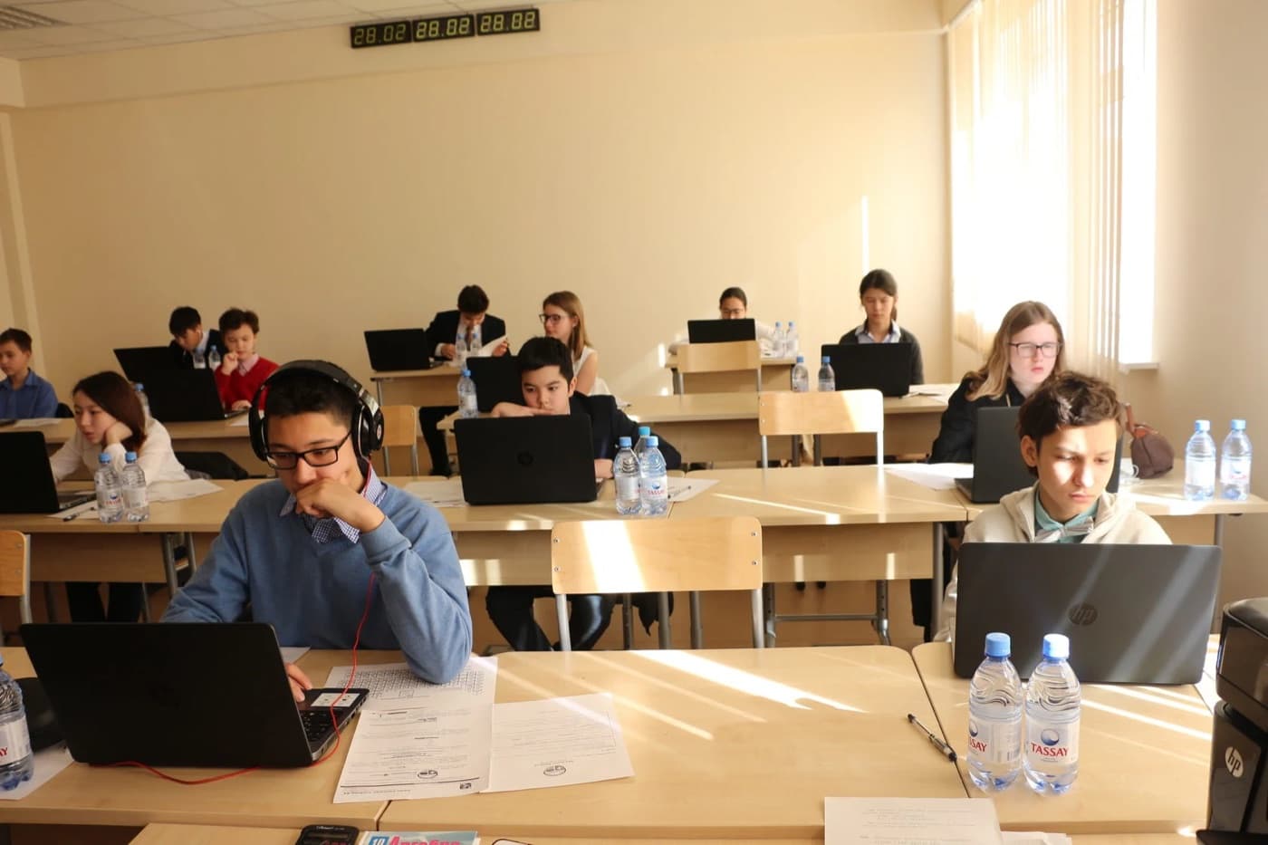 Students working on laptops during an olympiad